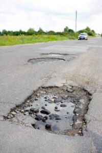 asphalt paving damage and pavement failure on a road